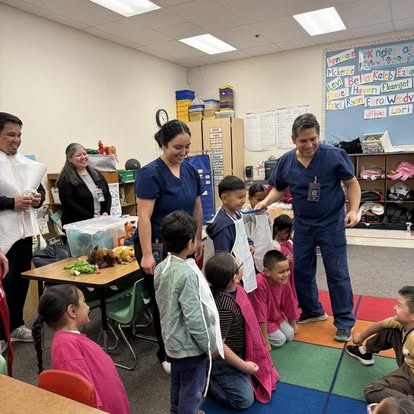 Dr. Castro and Dr. Hipona presenting dental education to elementary school children in classroom